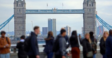People walk over London Bridge looking at a view of Tower Bridge in the City of London financial district, London, Britain, Oct. 25, 2023. (Reuters Photo)