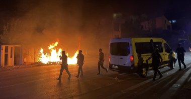 A shop burns up in flames as police officers intervene in a violent riot over the alleged abuse of a Syrian child by a Syrian man in central Kayseri province, Türkiye, July 1, 2024. (DHA Photo)