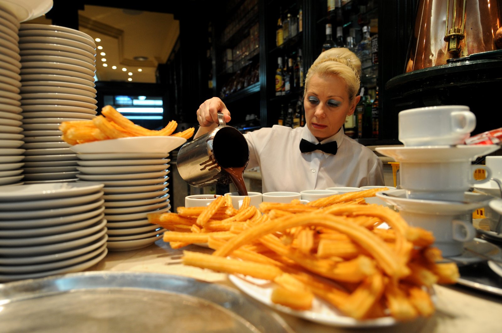 A waitress pours hot chocolate into cups to be served with Churros at the San Gines Chocolateria, Madrid, Spain, Oct. 23, 2009. (Getty Images Photo)