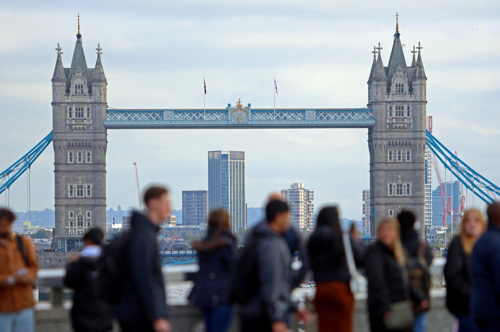 People walk over London Bridge looking at a view of Tower Bridge in the City of London financial district, London, Britain, Oct. 25, 2023. (Reuters Photo)