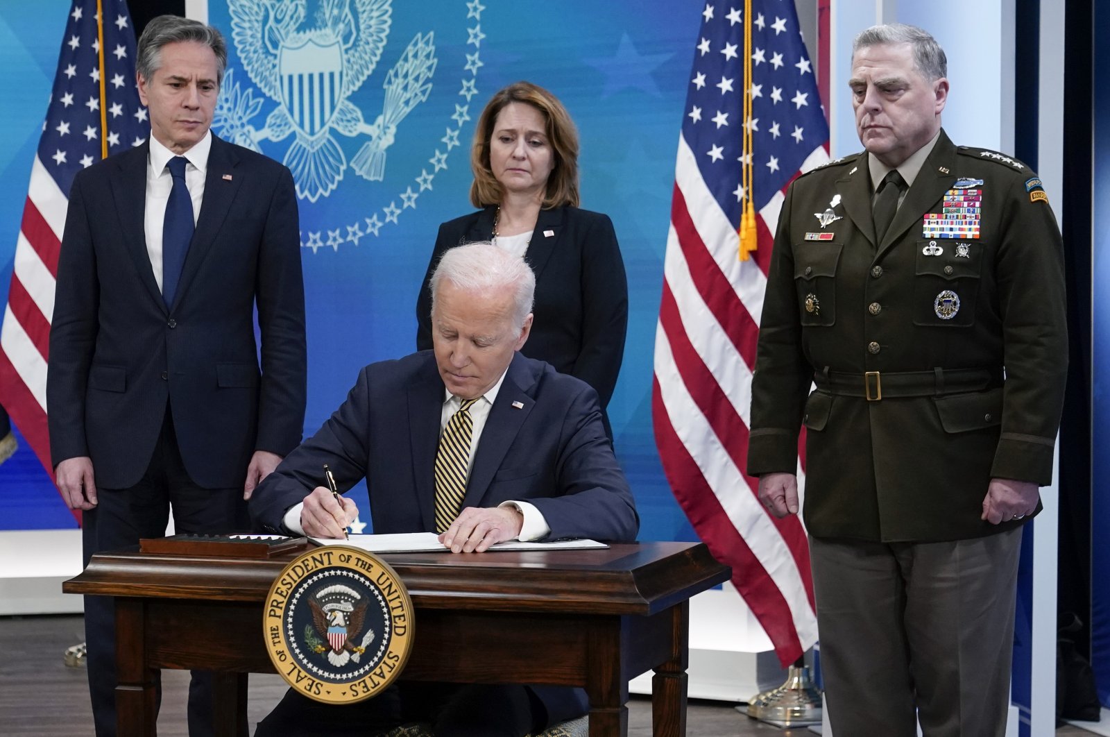 President Joe Biden signs a delegation of authority in the South Court Auditorium on the White House campus in Washington, Wednesday, March 16, 2022. (AP File Photo)
