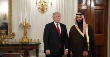 Then U.S. President Donald Trump stands with Saudi Arabia&#039;s defense minister, Deputy Crown Prince Mohammed bin Salman, before lunch in the State Dining Room of the White House, Washington, U.S., March 14, 2017. (AP Photo)