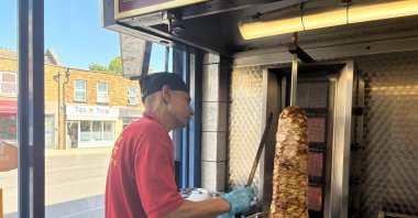 Ahmed Khan, the owner of Taylor Swift&#039;s "favorite" kebab shop, Kentish Delight, makes a kebab, London, U.K., June 20, 2024. (Reuters Photo)