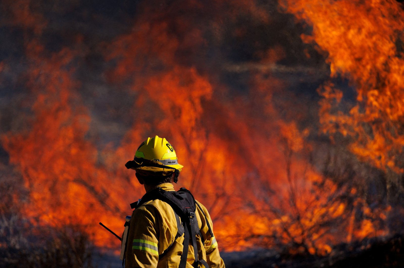 A firefighter works to extinguish the Highland Fire, a wind-driven wildfire near Aguanga, California, U.S., Oct. 31, 2023. (Reuters Photo)