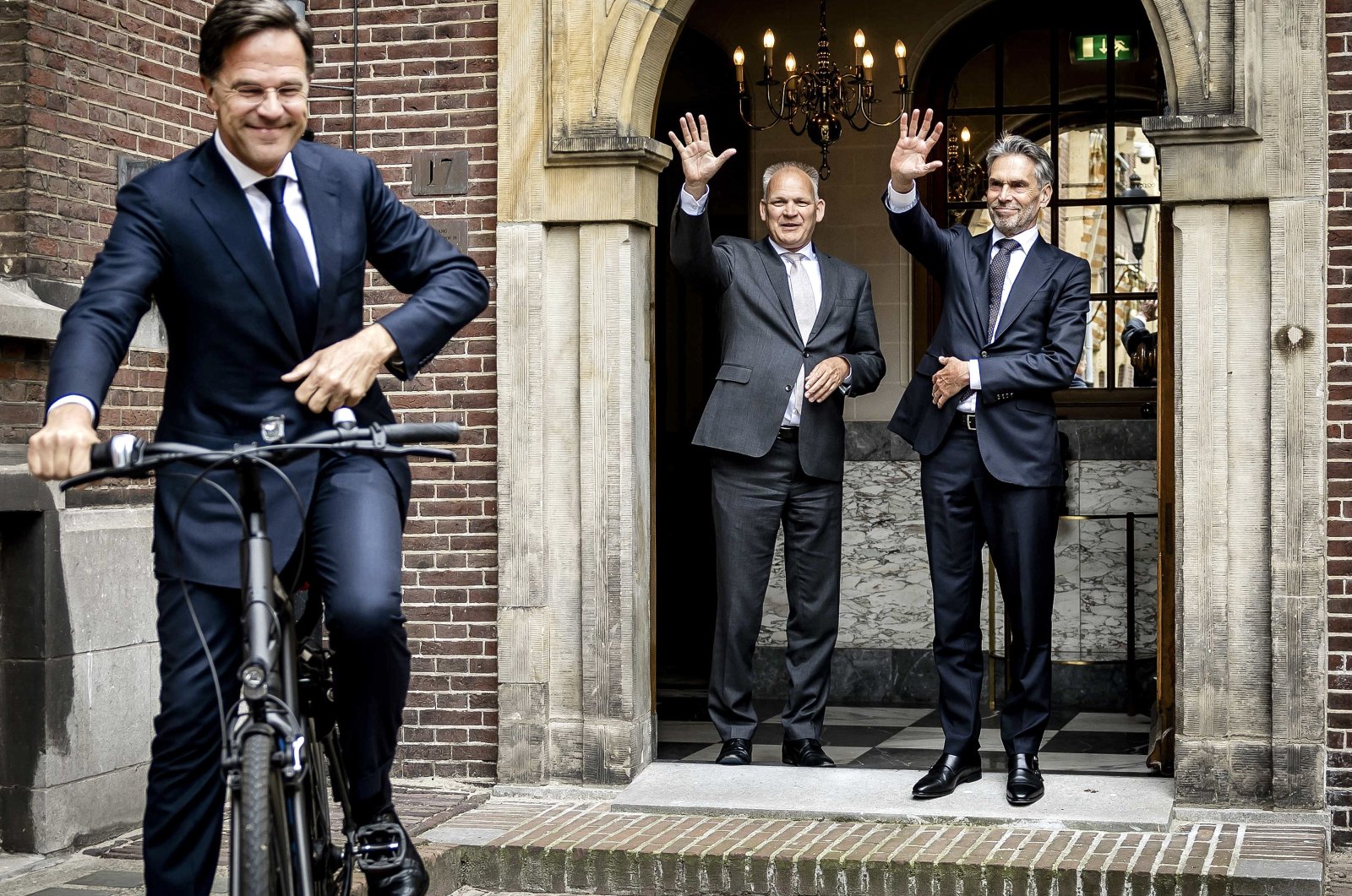 New Dutch Prime Minister Dick Schoof (R) with Secretary-General of the General Affairs Ministry, Gert-Jan Buitendijk (C) wave to former Dutch Prime Minister Mark Rutte as he leaves the Torentje, the Prime Minister&#039;s office, in The Hague, the Netherlands, July 2, 2024. (EPA Photo)
