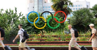 People walk past the Olympic rings displayed downtown for the Paris 2024 Olympic and Paralympic Games, Paris, France, July 1, 2024. (Reuters Photo)