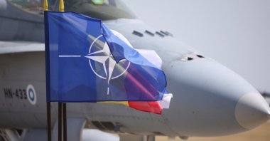 A Finnish Air Force F/A-18 fighter plane is seen near a NATO flag during the certification ceremony taking place at Mihail Kogalniceanu Air Base, Constanta, Romania, June 11, 2024. (Reuters Photo)
