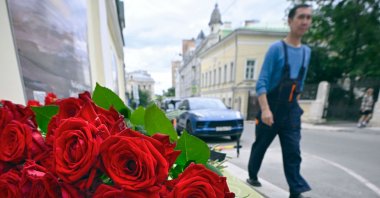 A man walks past the flowers lying in front of the representative office of Dagestan in Moscow, Russia, June 24, 2024. (AFP Photo)