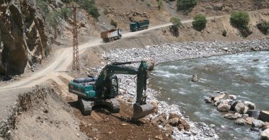 Bulldozers and trucks work on a road in Çukurca district, Hakkari, southeastern Türkiye, July 3, 2024. (AA Photo)