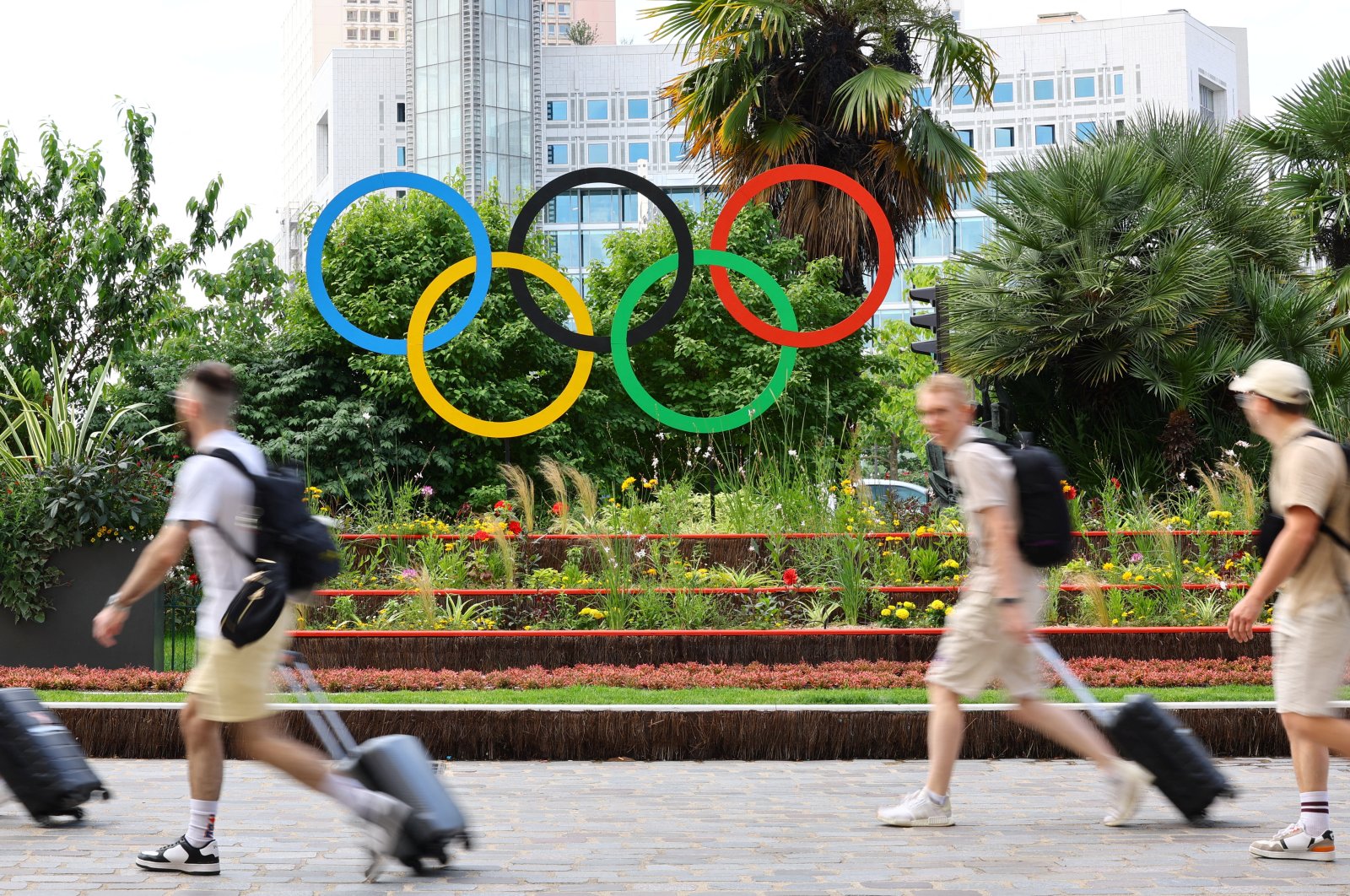 People walk past the Olympic rings displayed downtown for the Paris 2024 Olympic and Paralympic Games, Paris, France, July 1, 2024. (Reuters Photo)
