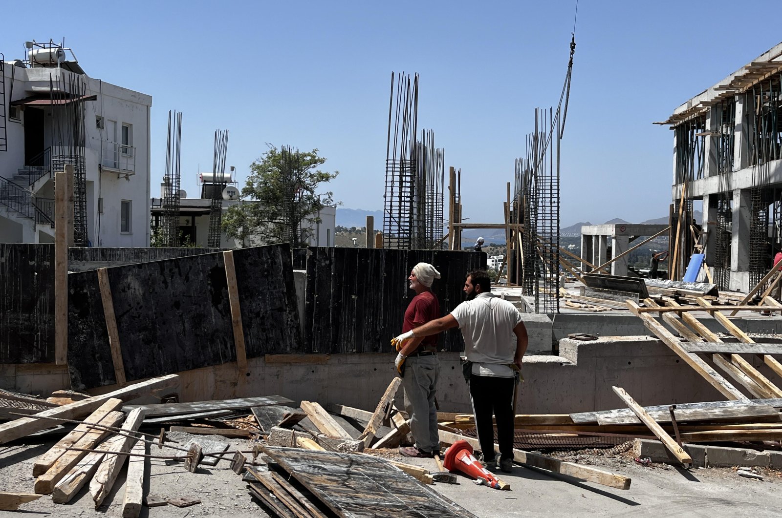 Construction workers are photographed on a site in the Bodrum district of Muğla province, southwestern Türkiye, June 4, 2024. (DHA Photo)