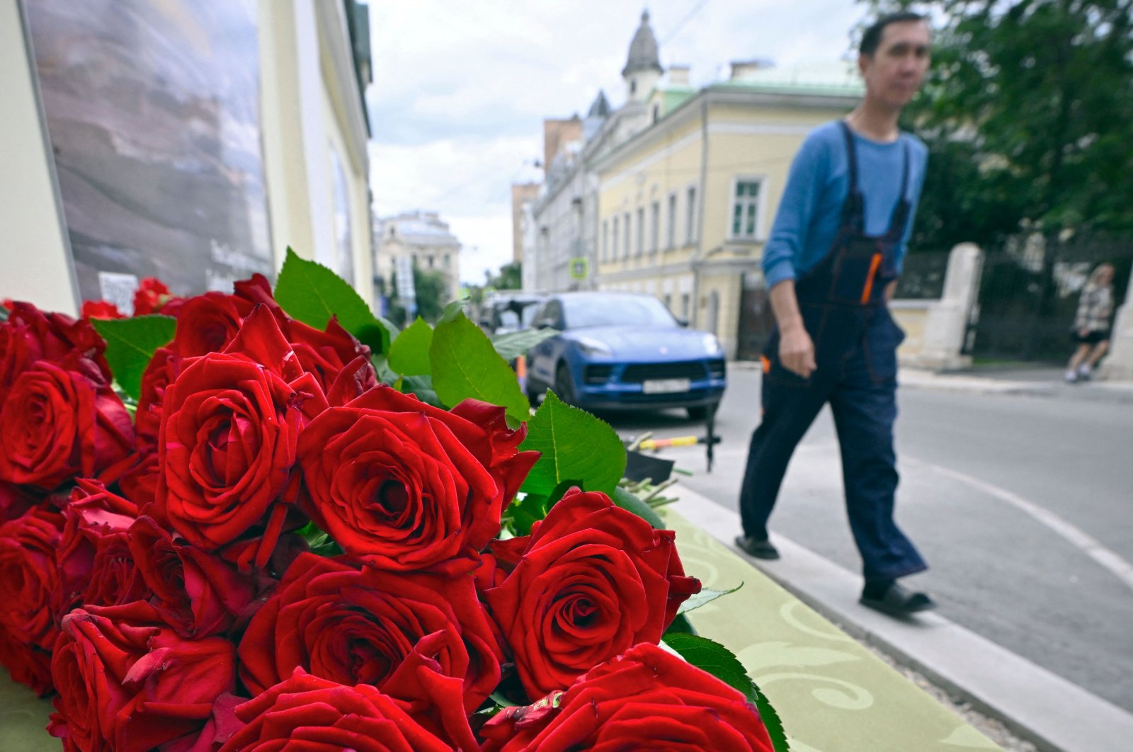A man walks past the flowers lying in front of the representative office of Dagestan in Moscow, Russia, June 24, 2024. (AFP Photo)