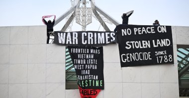 Pro-Palestine protesters hang banners from the top of Parliament House in Canberra, Australia, July 4, 2024. (EPA Photo)