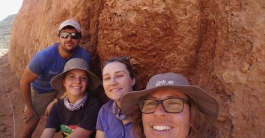 Michele Francis (R) and other researchers pose for a selfie next to an ancient termite mound in Namaqualand, South Africa, Sept. 15, 2018. (AP Photo)