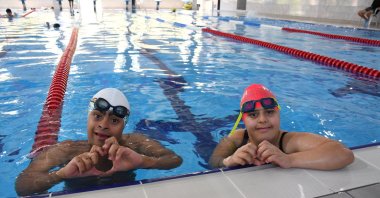 Turkish swimmers with Down syndrome Eren İçer (L) and Kumsal Dinibütün pose for a photo after a training session, Adana, Türkiye, July 4, 2024. (AA Photo)