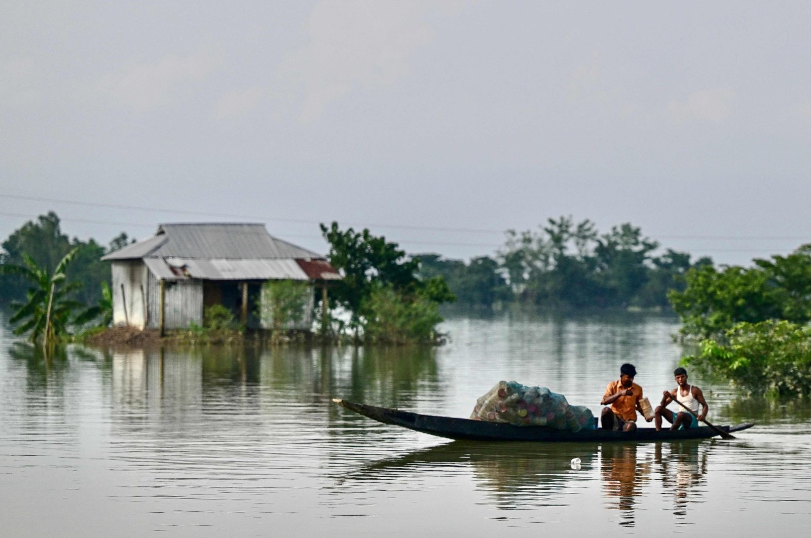 Fishermen at work in a flood-affected area of Sylhet, northeastern Bangladesh, June 21, 2024. (AFP Photo)