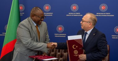 Turkish Maarif Foundation President Birol Akgün (R) and Zambian Foreign Minister Mulambo Haimbe sign a memorandum at the Foreign Ministry, Lusaka, Zambia, July 4, 2024. (AA Photo)