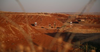 Turkish soldiers patrol as protestors stand near the Turkish military base during a protest, near Aleppo, Syria, July 1, 2024. (EPA Photo)