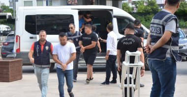 Police escort to the courthouse 11 suspects involved in attacks on Syrian-owned shops and vehicles in southern Antalya province, Türkiye, July 4, 2024. (DHA Photo)