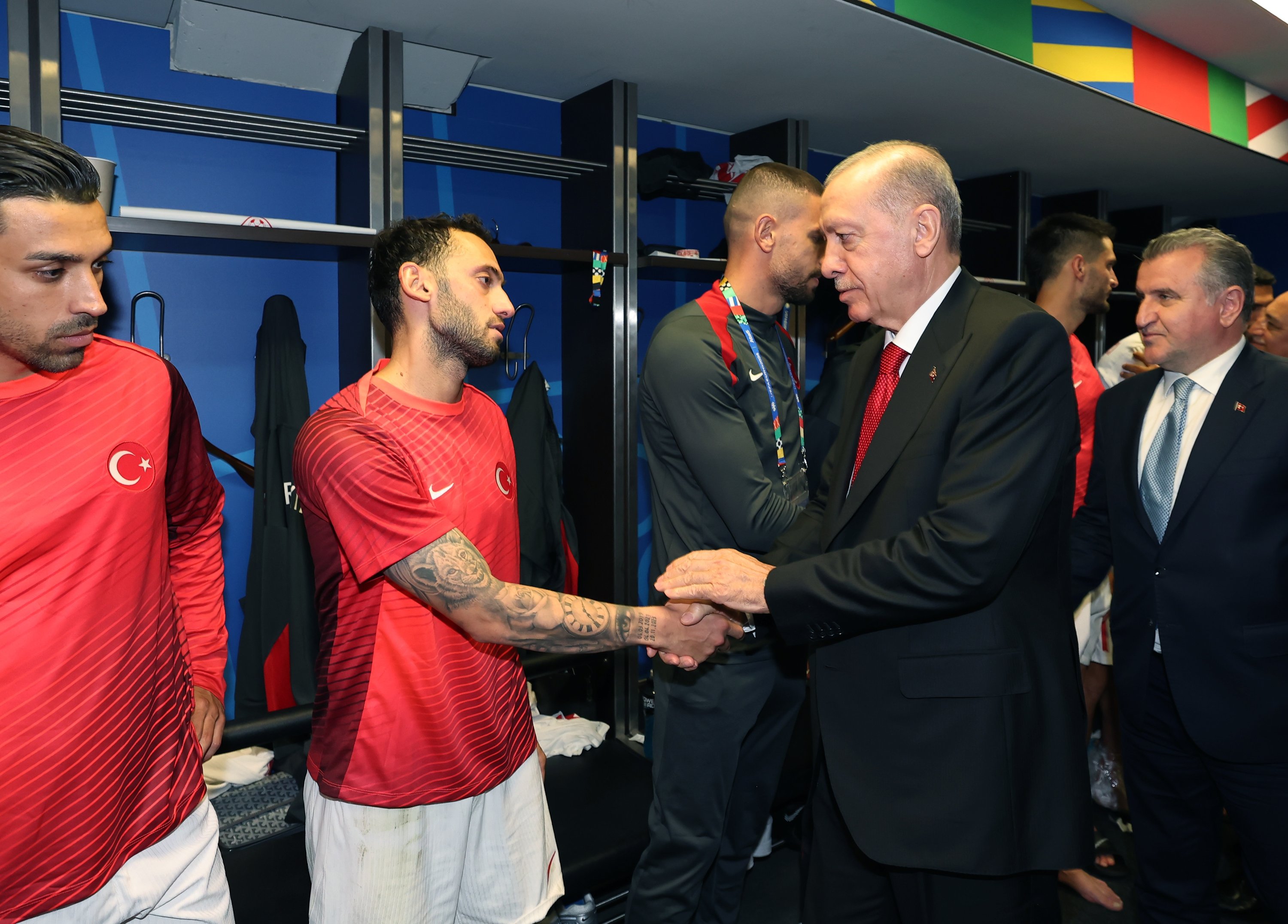 President Recep Tayyip Erdoğan talks to national team captain Hakan Çalhanoğlu after the Türkiye vs. Netherlands Euro 2024 quarterfinals match, Berlin, Germany, June 6, 2024. (DHA Photo)