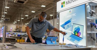 An employee builds a Microsoft Copilot  display at a Best Buy store as it begins selling Microsoft's new line of AI-centric Copilot  PCs to customers, Miami, Florida, U.S., June 18, 2024. (AFP Photo)