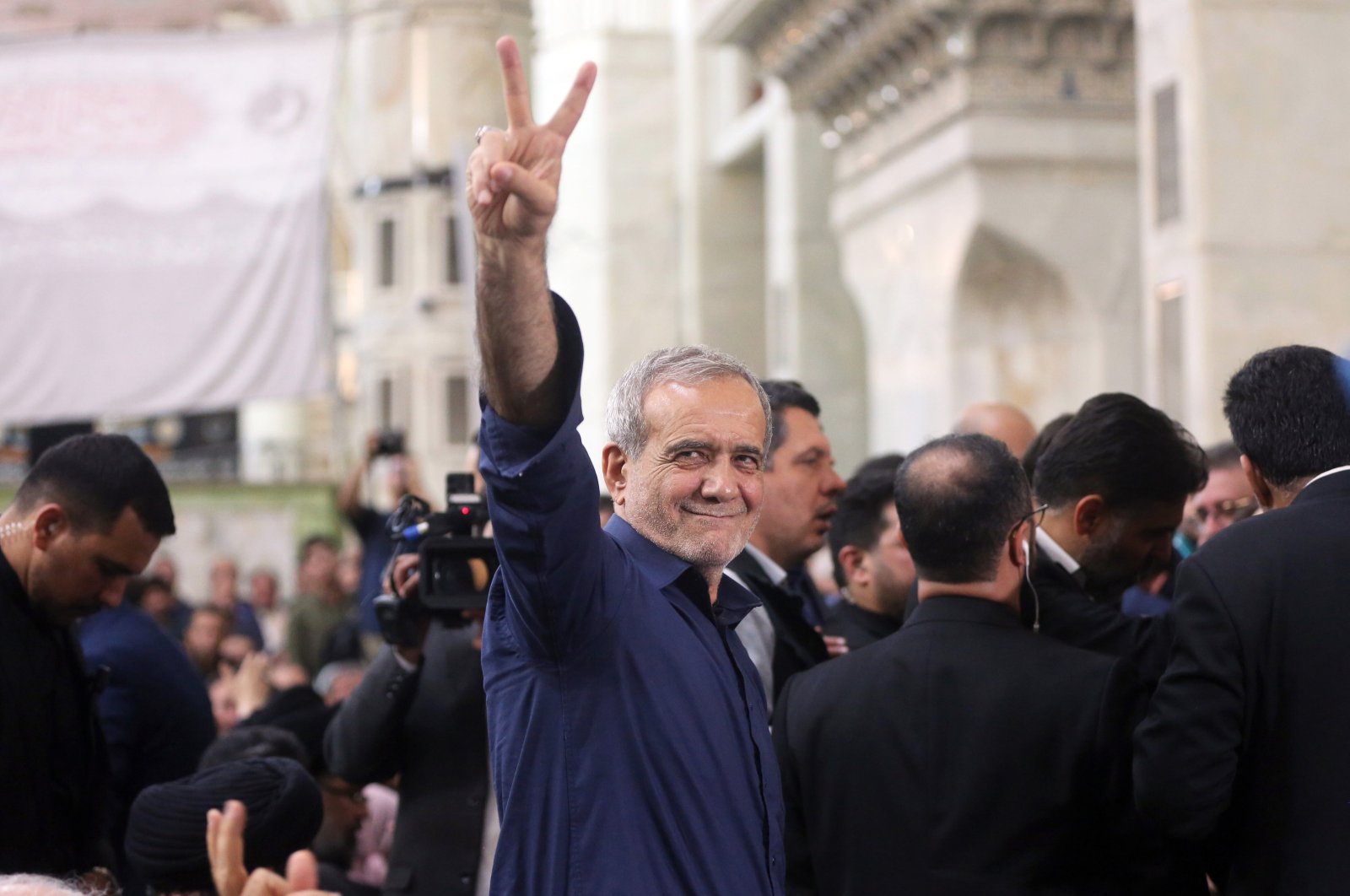 Iranian elected president Masoud Pezeshkian (C) flashes a victory sign to the crowd after winning the presidential elections, at the Khomeini shrine in southern Tehran, Iran, July 6, 2024. (EPA Photo)