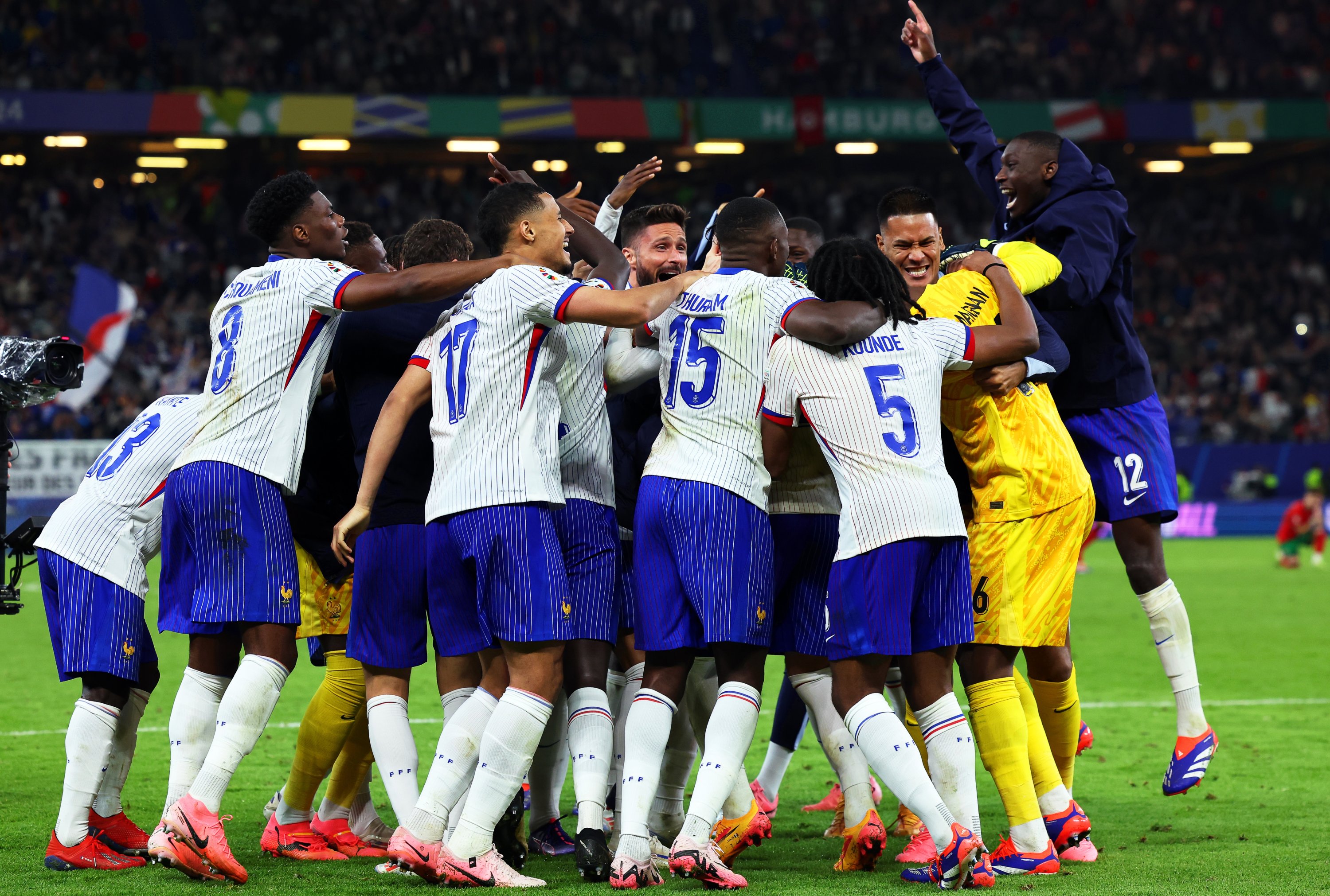 France's players cheer after the Euro 2024 quarterfinal penalty shoot-out against Portugal, Hamburg, Germany, July 6, 2024. (Getty Images Photo)