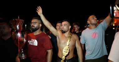 Yusuf Can Zeybek (C) celebrates after winning the 663rd Kırkpınar Oil Wrestling Festival title, Edirne, Türkiye, July 7, 2024. (IHA Photo)