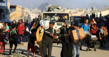 Palestinians, who fled the eastern part of Gaza City after they were ordered by Israeli army to evacuate their neighborhoods, carry their belongings, Gaza City, Palestine, July 7, 2024. (Reuters Photo)