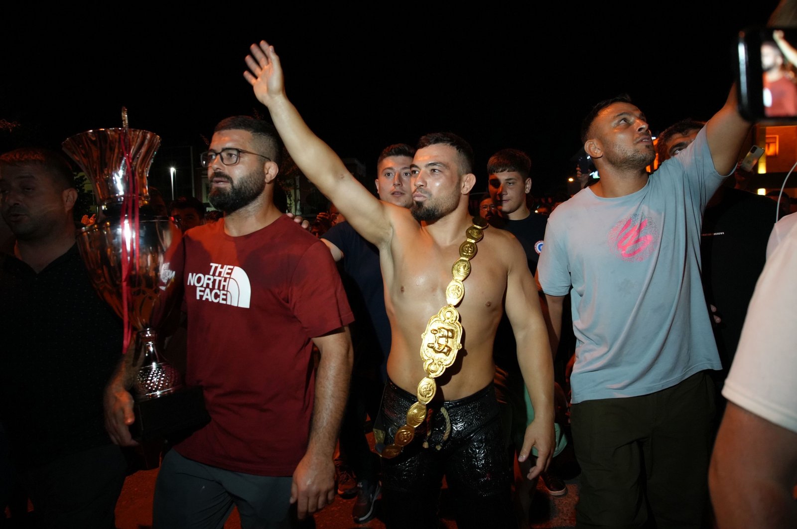 Yusuf Can Zeybek (C) celebrates after winning the 663rd Kırkpınar Oil Wrestling Festival title, Edirne, Türkiye, July 7, 2024. (IHA Photo)