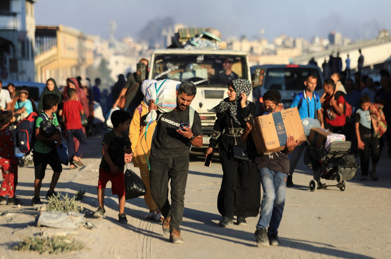 Palestinians, who fled the eastern part of Gaza City after they were ordered by Israeli army to evacuate their neighborhoods, carry their belongings, Gaza City, Palestine, July 7, 2024. (Reuters Photo)