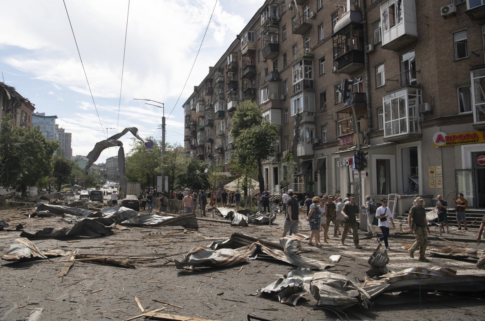 People walk in a street covered with debris after a missile strike in Kyiv, Ukraine, July 8, 2024. (EPA Photo)