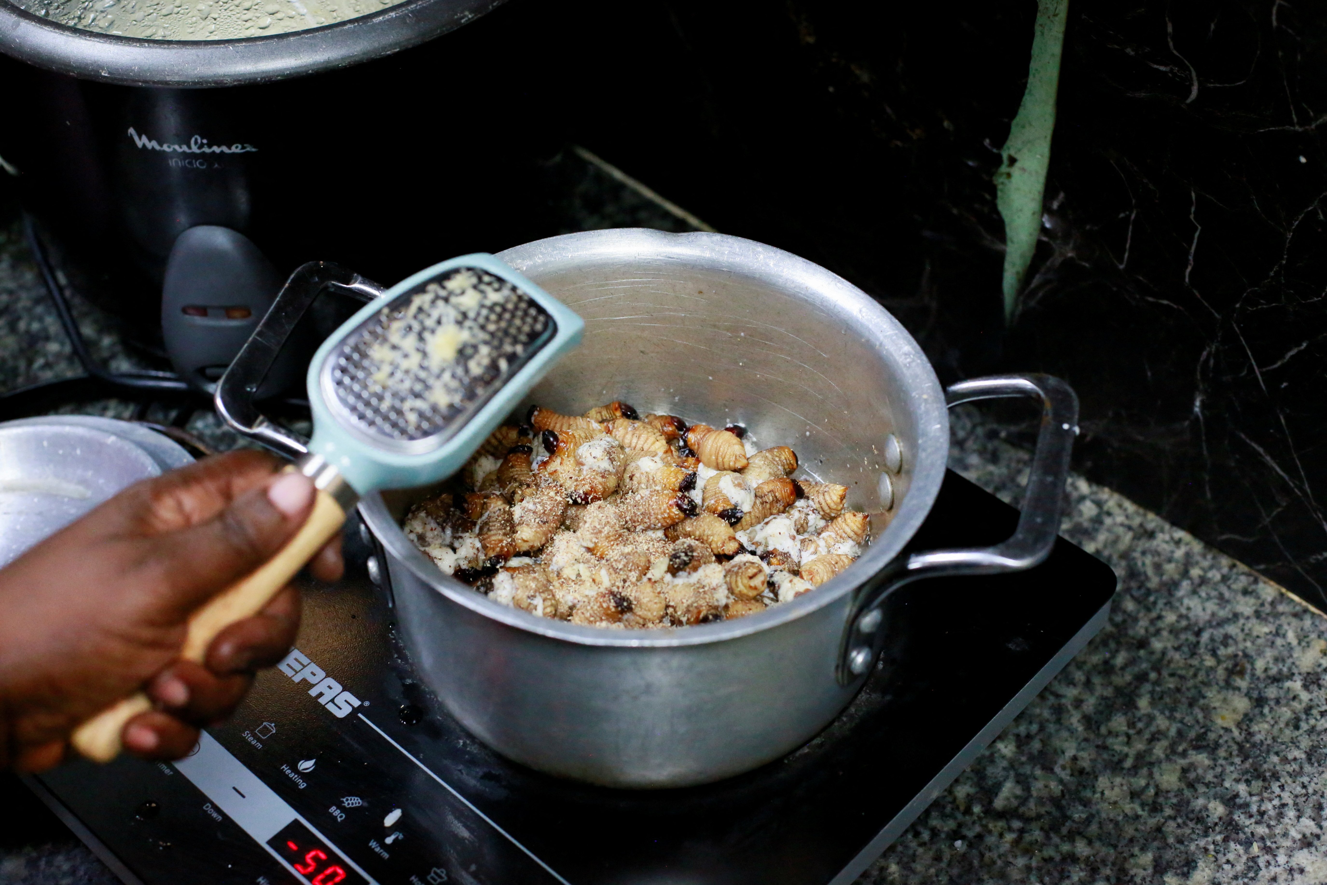 Palm larvae while being cooked at a restaurant kitchen in Kinshasa, Democratic Republic of Congo, May 24,  2024. (Reuters Photo)