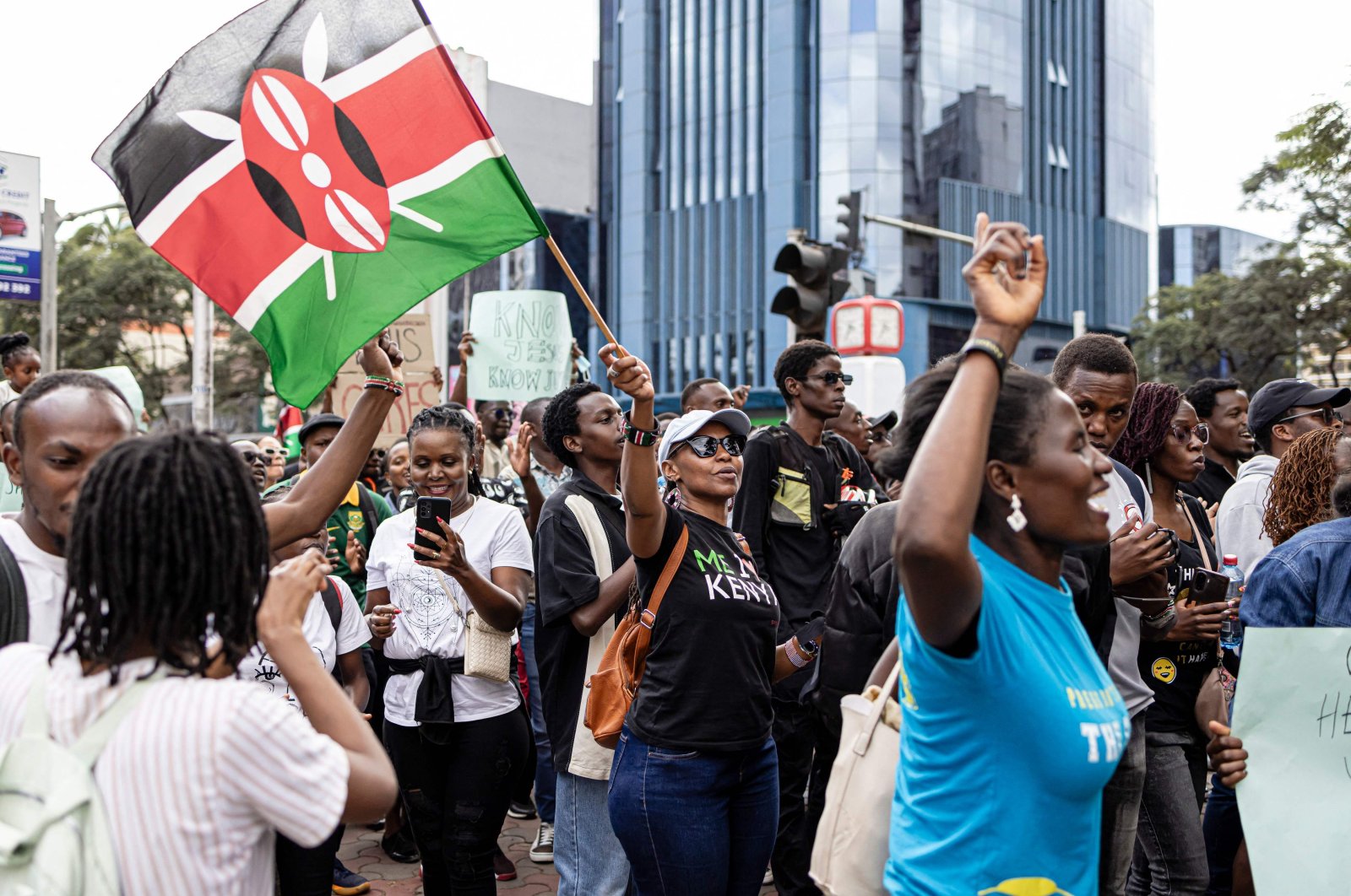 A woman waves a Kenyan flag while marching against the Finance Bill 2024 in downtown Nairobi, Kenya,  June 23, 2024. (AFP Photo)