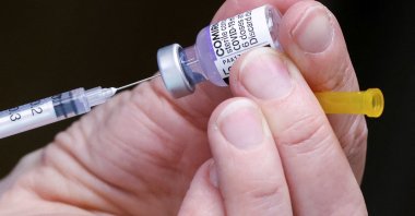 A medical staff member prepares a booster dose of Pfizer&#039;s COVID-19 vaccine at a vaccination center, Brussels, Belgium, Jan. 5, 2022. (Reuters Photo)