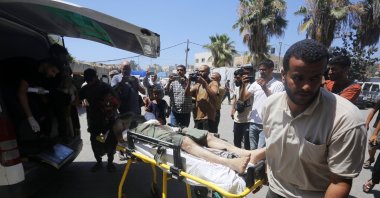 People carry the injured to a hospital after an Israeli attack on a refugee camp, Deir al-Balah, Gaza Strip, Palestine, July 9, 2024. (AA Photo)