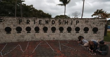 Anti-war demonstrators line up candles to spell "No War!," at the Torch of Friendship monument, in Miami, U.S., Jan. 9, 2020. (AP Photo)