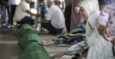 Women mourn beside the coffins of exhumed bodies of their loved ones near Potocari, Bosnia-Herzegovina, July 9, 2024. (AA Photo)