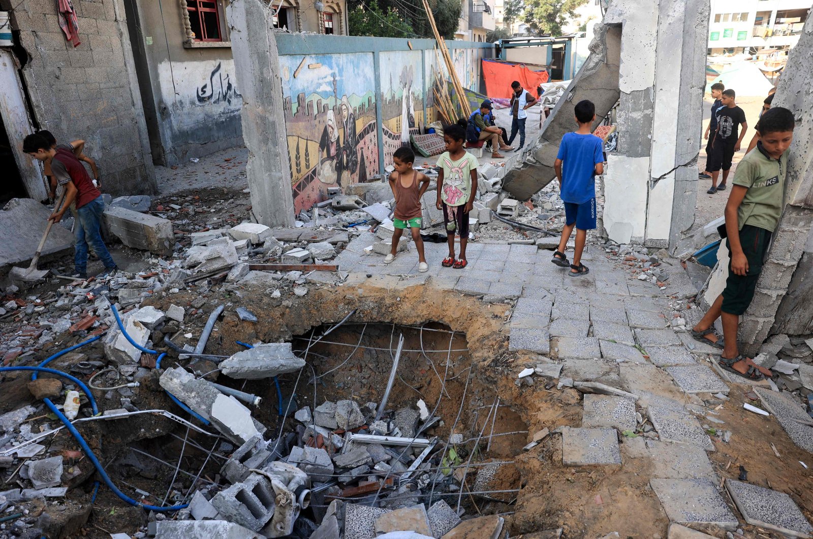 Children check the destruction at a U.N.-run school after Israeli bombardment in Nuseirat, Gaza Strip, Palestine, July 9, 2024. (AFP Photo)