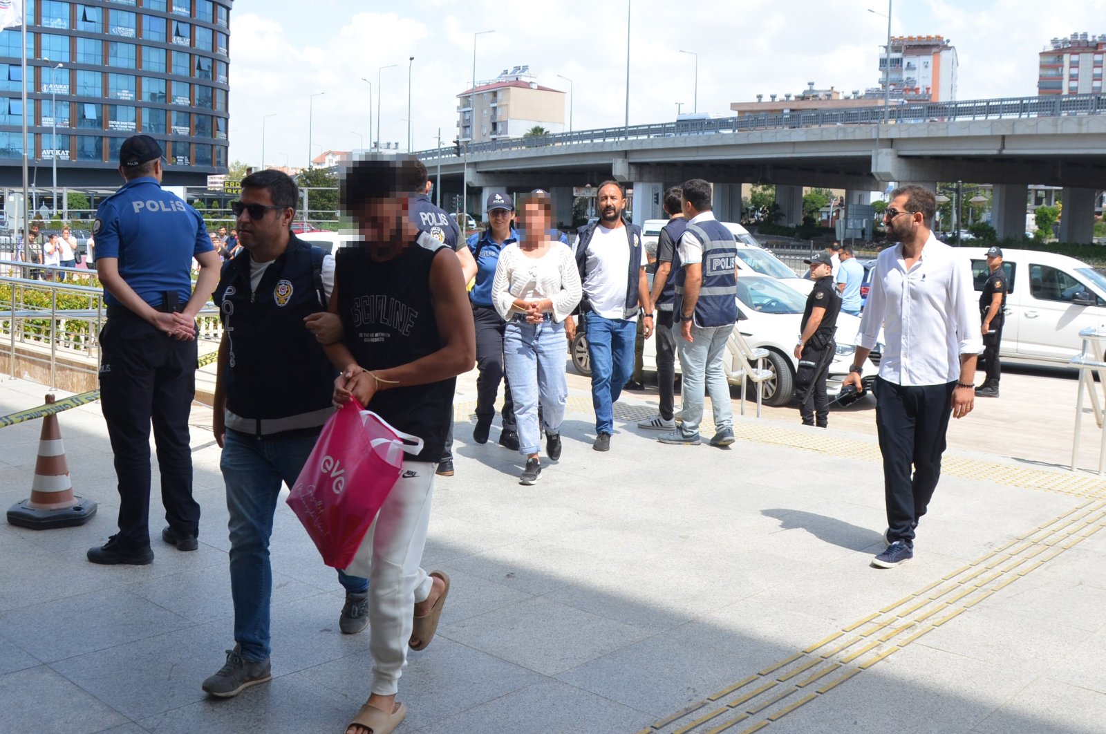 Police escort suspects involved in anti-Syrian riots, Antalya, southern Türkiye, July 4, 2024. (DHA Photo)