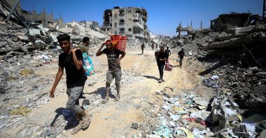Palestinians make their way as they inspect the damage following an Israeli ground operation in the eastern part of Gaza City, Palestine, July 10, 2024. (Reuters Photo)