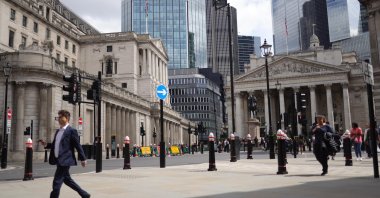 People walk past the Bank of England in the City of London financial district, London, U.K., June 19, 2024. (EPA Photo)