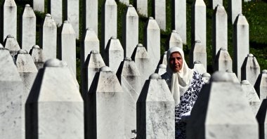 Bosnian Muslim survivor of the 1995 Srebrenica genocide stands among headstones at the memorial cemetery in village of Potocari, Srebrenica, Bosnia, July 11, 2024. (AFP Photo)