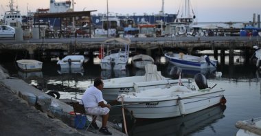 A man fishes in the port of Gazimağusa, in the Turkish Republic of Northern Cyprus, Aug. 14, 2022. (Reuters File Photo)