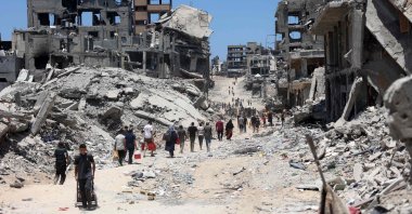Palestinians walk through the rubble of destroyed buildings after the Israeli military withdrew following a two-week assault on the Shujaiya neighborhood, east of Gaza City, Palestine, July 11, 2024. (AFP Photo)