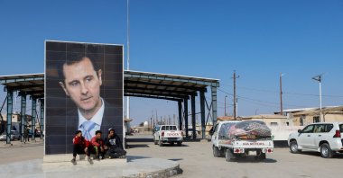 A picture of Syrian leader Bashar Assad is seen on a road where vehicles containing aid from Hashd al-Shaabi (Popular Mobilization Forces) head to Syria to support victims of the deadly earthquake, on the Syrian side of the Iraq-Syria border, Syria, Feb. 12, 2023. (Reuters Photo)