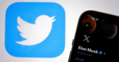 The new logo of Twitter is seen on Elon Musk’s Twitter account on an iPhone as the old Twitter logo is displayed on a MacBook screen in Galway, Ireland July 24, 2023. (Reuters File Photo)