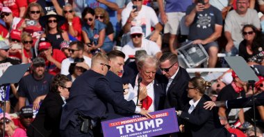 
Republican presidential candidate and former U.S. President Donald Trump is assisted by U.S. Secret Service personnel after gunfire rang out during a campaign rally at the Butler Farm Show in Butler, Pennsylvania, U.S., July 13, 2024. (Reuters Photo)