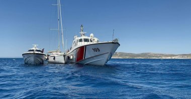 A view of a sailboat sandwiched between Turkish security forces' boats off the coast of Izmir, western Türkiye, July 14, 2024. 