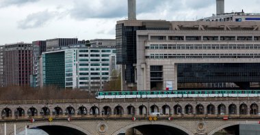 A view shows the Bercy Economy and Finance Ministry as a metro operated by the Paris transport network RATP passes over the Pont de Bercy bridge in Paris, France, March 29, 2024. (Reuters Photo)